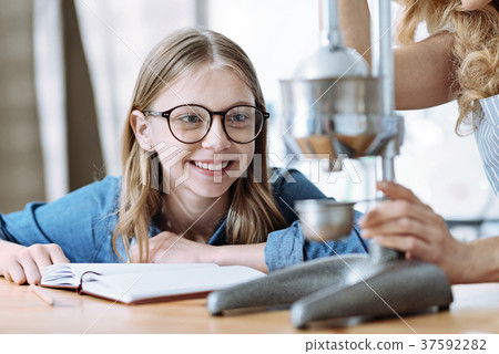 Portrait of smiling girl that looking at kitchen 37592282