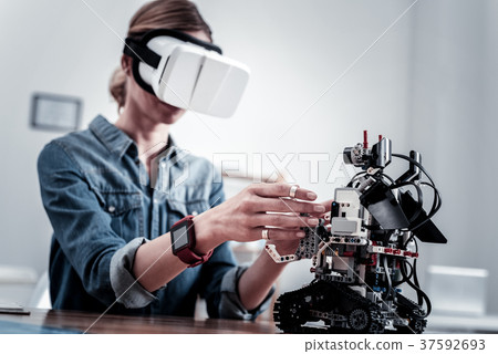 Competent woman testing new gadget 37592693