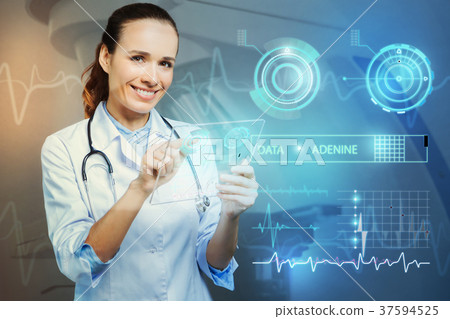 Smiling doctor looking happy while standing with a Smiling doctor looking happy while standing with a 37594525