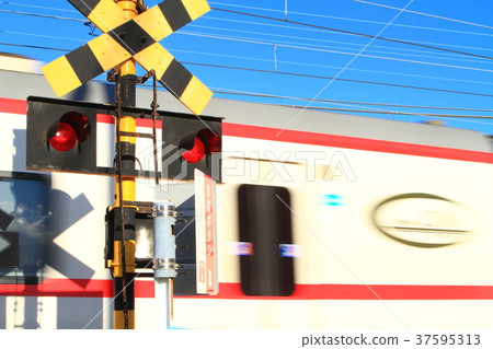 A train passing through a railroad crossing A train passing through a railroad crossing 37595313