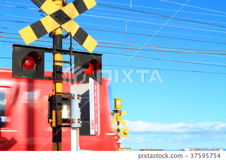 A train passing through a railroad crossing A train passing through a railroad crossing 37595754