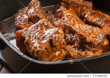 Pork spare ribs on dish in own sauce 37596042