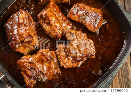 Pork spare ribs on dish in own sauce 37596043