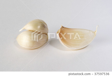 Garlic slices, isolated, on white background. Garlic slices, isolated, on white background. 37597536