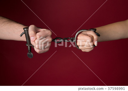 male and female hands are handcuffed. 37598991