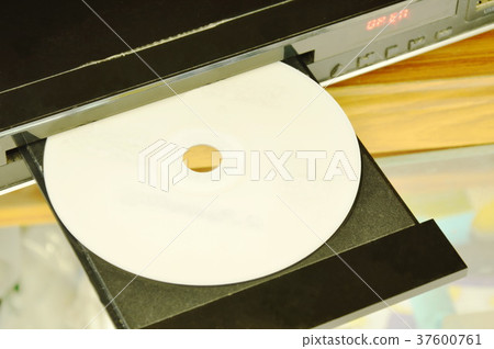 DVD put on insert disc player in wooden cupboard DVD put on insert disc player in wooden cupboard 37600761