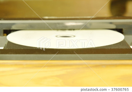 DVD put on insert disc player in wooden cupboard 37600765