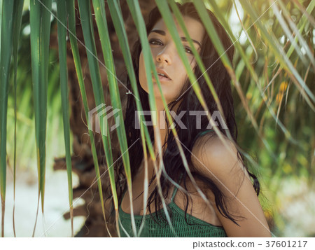 Beautiful girl posing in tropical forest. Close-up Beautiful girl posing in tropical forest. Close-up 37601217