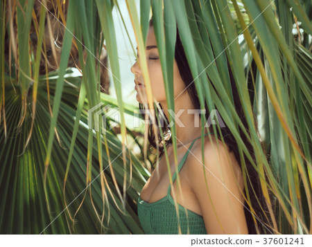 Beautiful girl posing in tropical forest. Close-up Beautiful girl posing in tropical forest. Close-up 37601241