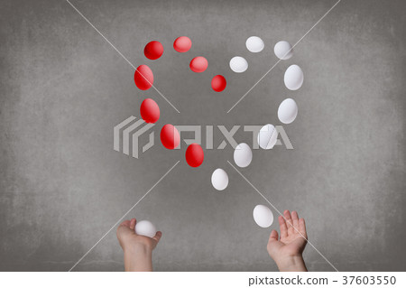 Female hands juggle eggs in the form of Valentine Female hands juggle eggs in the form of Valentine 37603550