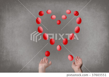 Female hands juggle eggs in the form of Valentine Female hands juggle eggs in the form of Valentine 37603551