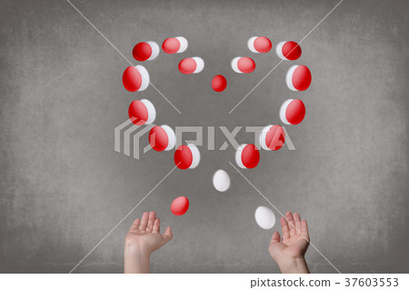 Female hands juggle eggs in the form of Valentine 37603553