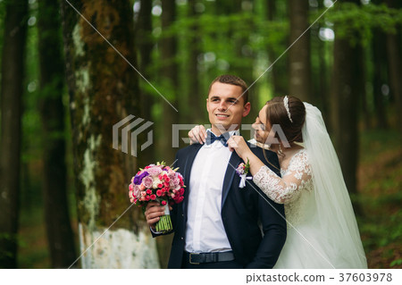 The newlyweds are walking in the park on the 37603978