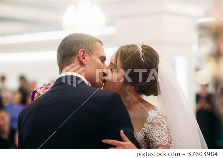 The newlyweds are walking in the park on the The newlyweds are walking in the park on the 37603984
