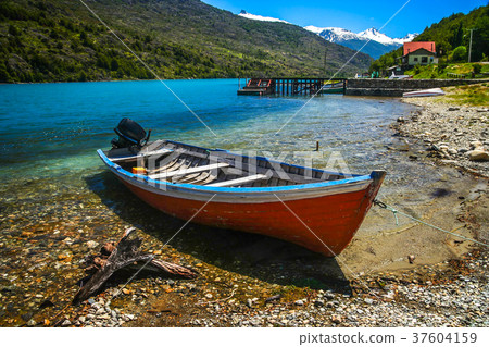 Small boat on Patagonian lakeshore 37604159