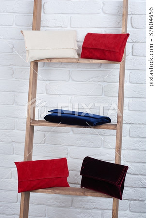 Five women s bags on the white wall background Five women s bags on the white wall background 37604656
