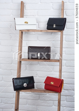 Five women s leather bags on the white wall Five women s leather bags on the white wall 37604659