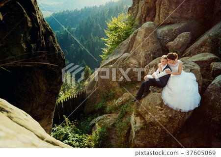 Gorgeous bride is softly hugging the smiling Gorgeous bride is softly hugging the smiling 37605069