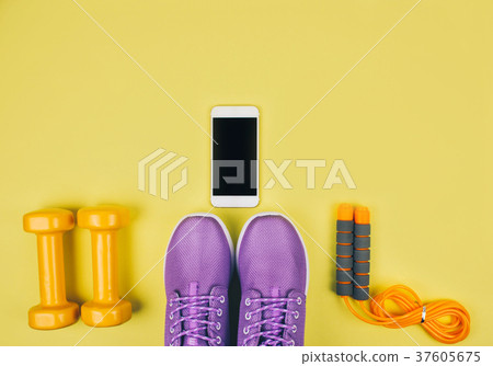 Flat lay shot of sneakers, dumbbells, jump rope or 37605675