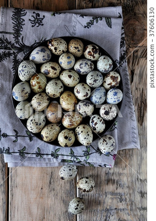 On cotton napkins quail eggs on a platter, wooden 37606130