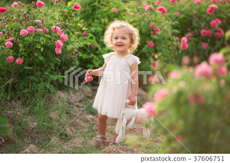 Pretty curly child girl is walking in spring 37606751