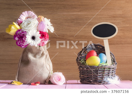Flowers and Easter basket with a banner Flowers and Easter basket with a banner 37607156