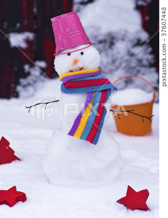 snowman with a bucket on his head on white snow snowman with a bucket on his head on white snow 37607448