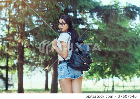 Young woman traveler with backpack standing alone 37607546