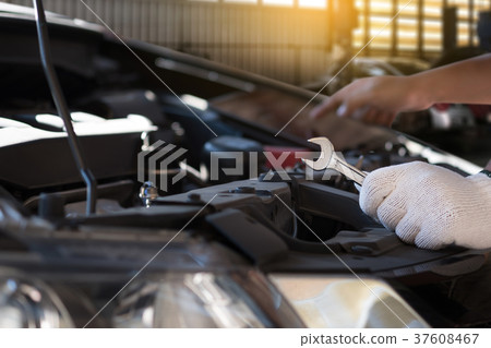 Mechanic repairing a car in garage Auto repair Mechanic repairing a car in garage Auto repair 37608467