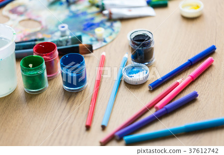 gouache colors, felt tip pens and pencils on table gouache colors, felt tip pens and pencils on table 37612742