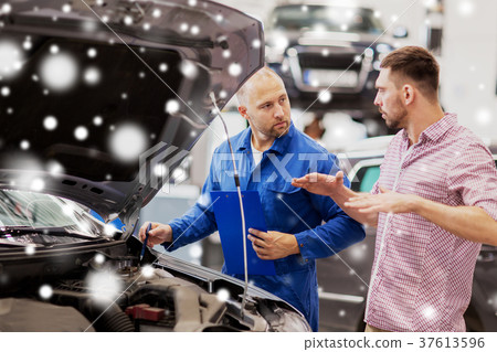 auto mechanic with clipboard and man at car shop auto mechanic with clipboard and man at car shop 37613596