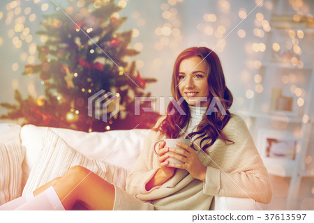 happy woman with cup of tea at home for christmas happy woman with cup of tea at home for christmas 37613597