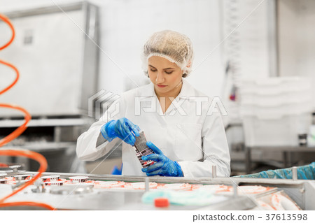 woman working at ice cream factory conveyor woman working at ice cream factory conveyor 37613598