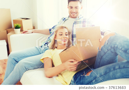 happy couple with big cardboard boxes at new home 37613683
