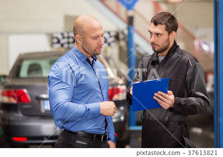 auto mechanic and customer at car shop 37613821