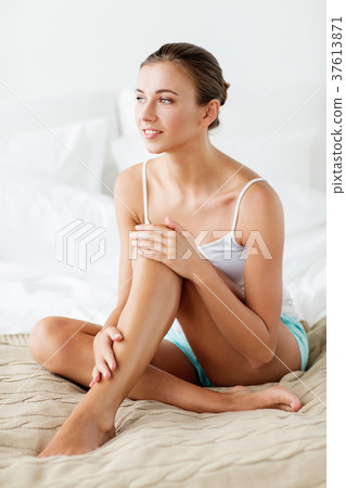 beautiful woman with bare legs on bed at home beautiful woman with bare legs on bed at home 37613871