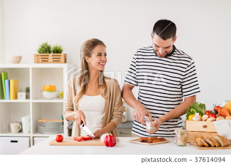 happy couple cooking food at home kitchen 37614094