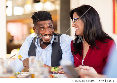 happy couple eating at restaurant 37614303