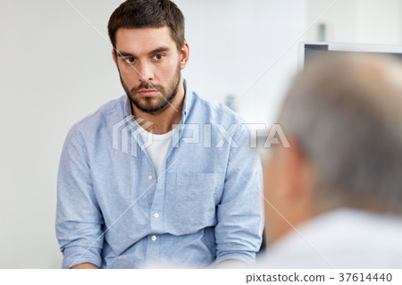 young male patient talking to doctor at hospital young male patient talking to doctor at hospital 37614440