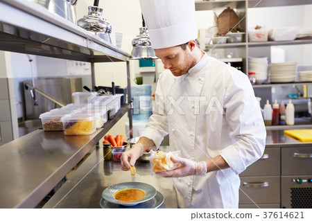 happy male chef cooking food at restaurant kitchen 37614621