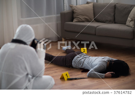criminalist photographing dead body at crime scene criminalist photographing dead body at crime scene 37614782