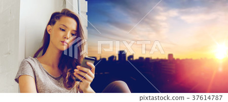 sad pretty teenage girl with smartphone texting sad pretty teenage girl with smartphone texting 37614787