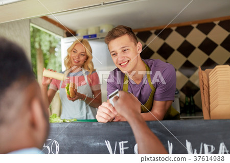 salesman taking customer credit card at food truck salesman taking customer credit card at food truck 37614988