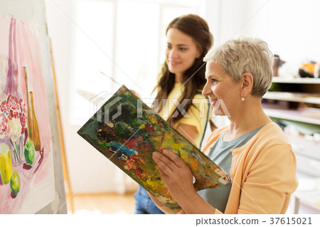 happy women painting at art school studio 37615021