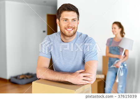 happy couple with boxes moving to new home happy couple with boxes moving to new home 37615039