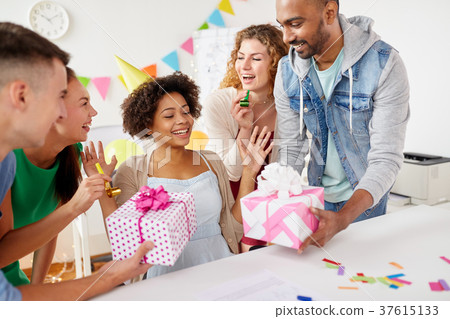 team greeting colleague at office birthday party team greeting colleague at office birthday party 37615133