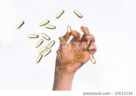 hand picking cod liver oil capsules up hand picking cod liver oil capsules up 37615134