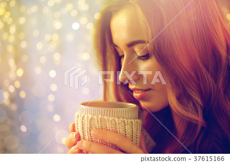 close up of happy woman with tea or coffee cup close up of happy woman with tea or coffee cup 37615166