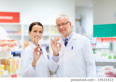 apothecaries at pharmacy showing ok hand sign 37615413