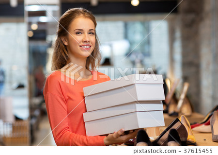woman or shop assistant with shoe boxes at store woman or shop assistant with shoe boxes at store 37615455
